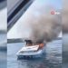 Yanan tekneden denize atlayarak kurtuldular